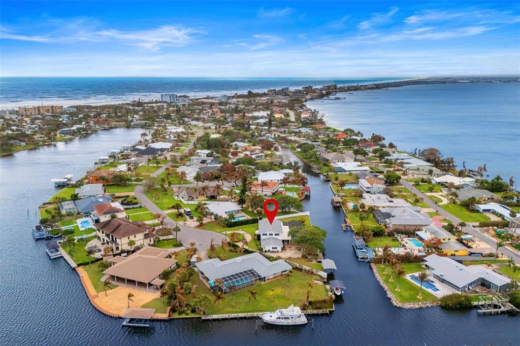 An aerial view of a waterfront residential property with a boat dock and swimming pool — 1790 BAY SHORE DRIVE, COCOA BEACH, FL