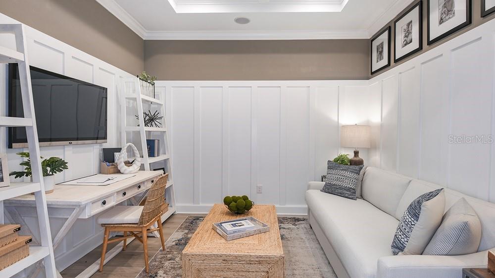 A home office features a white desk, a sofa, and white board-and-batten wall paneling — 7452 MOONBEAM AVENUE, SARASOTA, FL