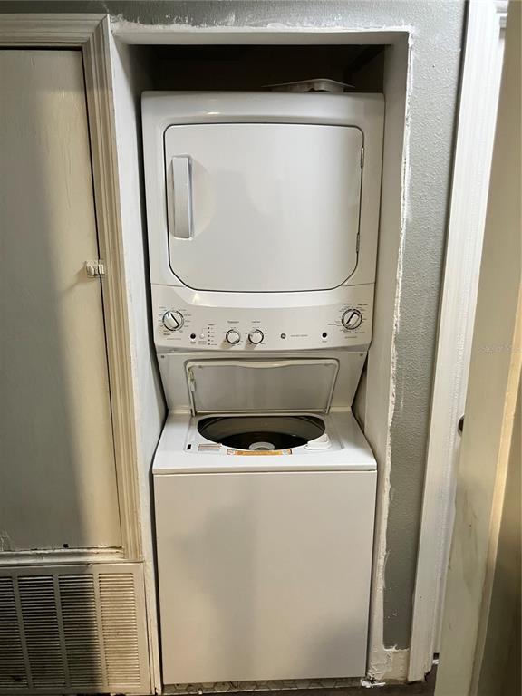 A white stacked washer and dryer unit is installed in a recessed laundry closet — 4409 19TH STREET CIRCLE W, BRADENTON, FL