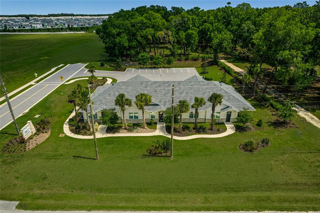 An aerial view of a single-story commercial building with a parking lot and landscaping — 6601 SW 80TH AVENUE, OCALA, FL