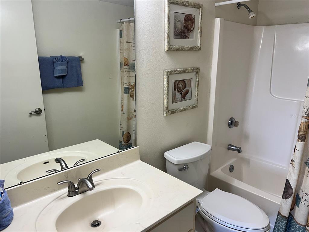 A bathroom features a vanity with a sink, a toilet, and a shower-tub combination — 1001 POINT OF ROCKS ROAD UNIT 408, SARASOTA, FL