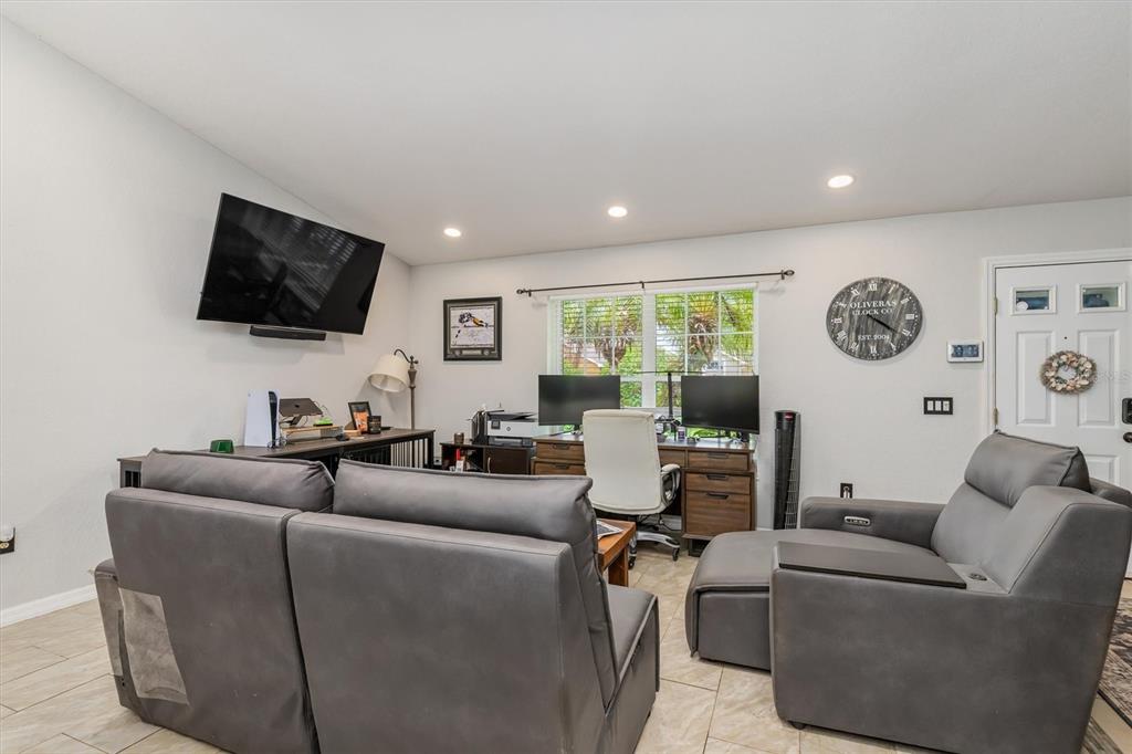 A living room and home office combination with gray leather furniture and tile flooring — 26550 VALPARAISO DRIVE, PUNTA GORDA, FL