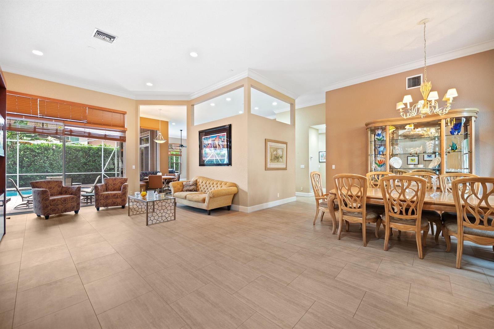 A spacious open-concept living and dining area features tile flooring, neutral walls, and large windows — 77 NW 108th Way, Plantation FL 33324, PLANTATION, FL
