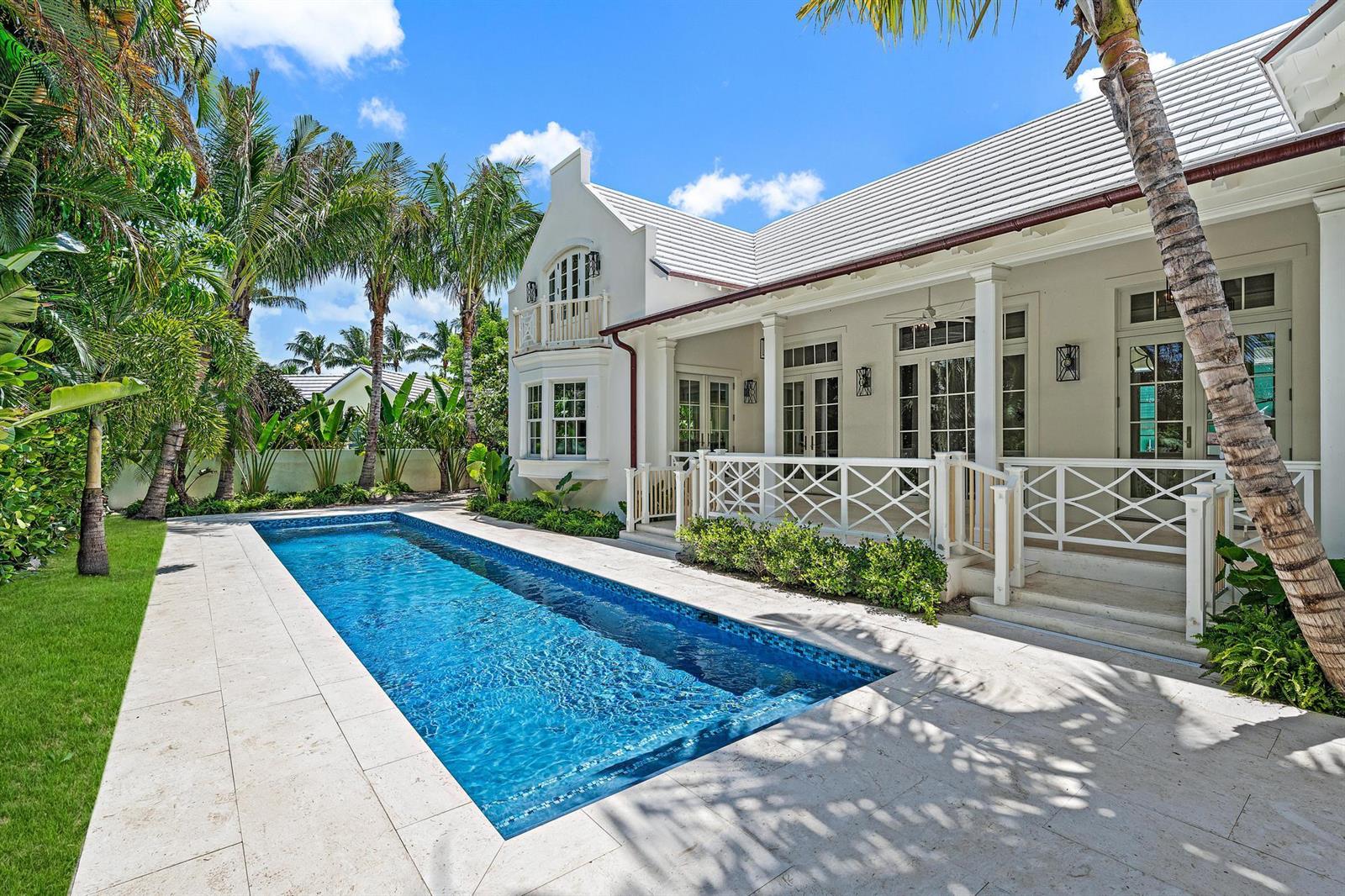 A rectangular swimming pool sits on a stone patio beside a white house with palm trees — 269 Jamaica Lane, Palm Beach FL 33480, PALM BEACH, FL