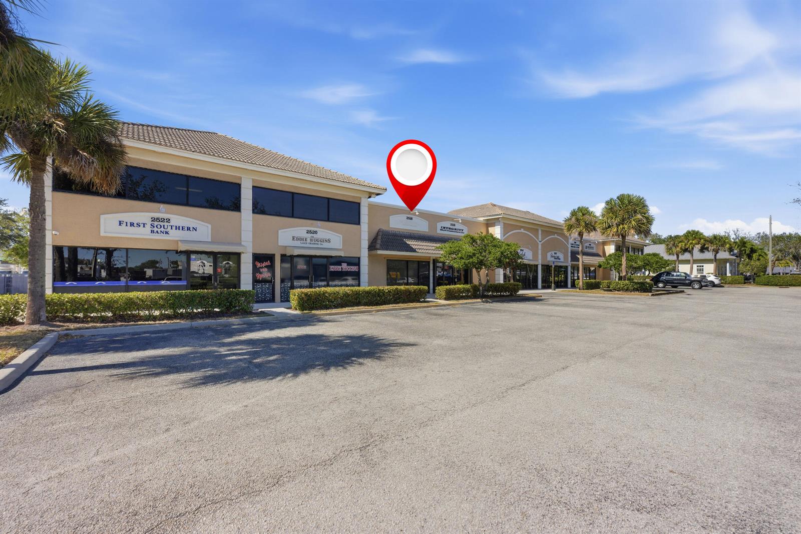 A red location pin marks a commercial building with multiple storefronts in a parking lot — 2518 SE Willoughby Boulevard # 2518, Stuart FL 34994, STUART, FL