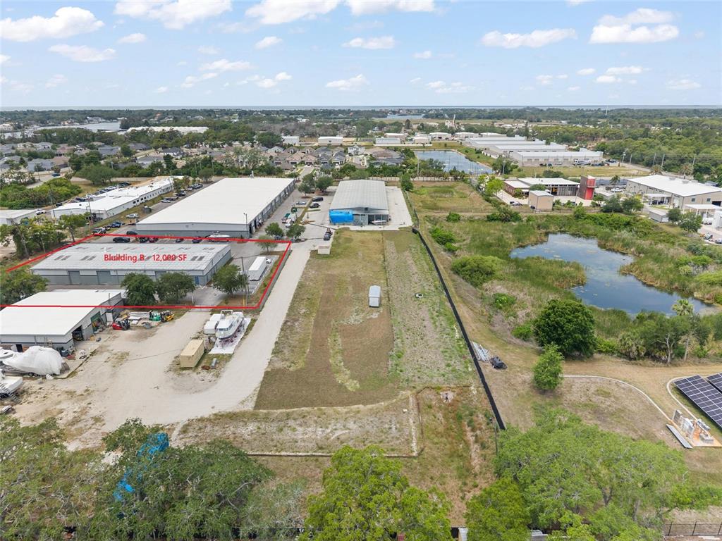 An aerial view shows a commercial warehouse building with a red outline on a lot — 1468 L AND R INDUSTRIAL BOULEVARD Bldg. B, TARPON SPRINGS, FL