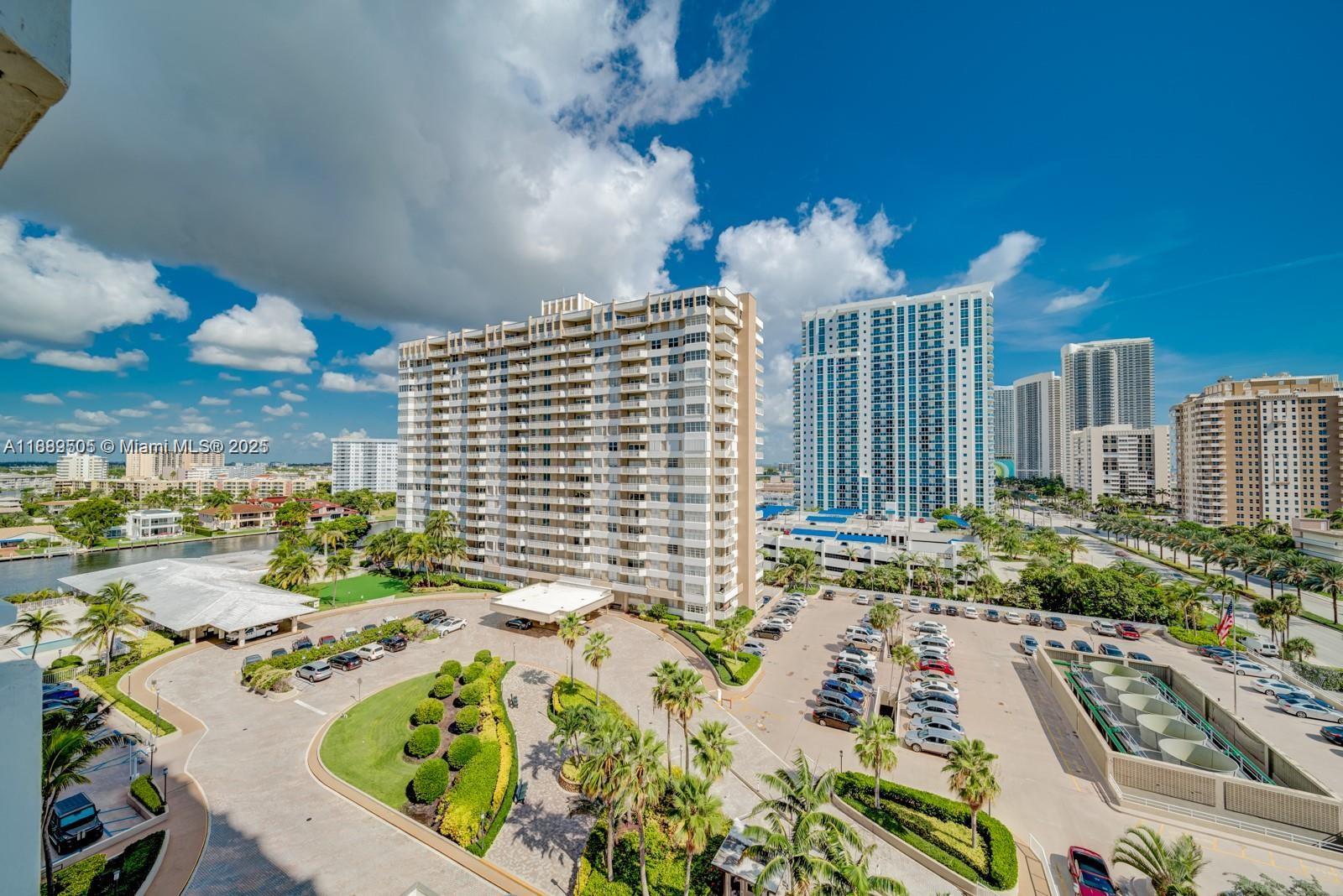 An elevated view shows a large apartment complex with a parking lot and landscaping — 1985 S Ocean Dr # 15A, Hallandale Beach FL 33009, HALLANDALE BEACH, FL