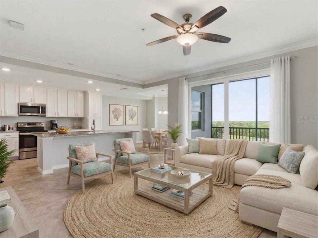 A living room and kitchen with a ceiling fan, sectional sofa, and large sliding glass doors — 14081 HERITAGE LANDING BOULEVARD UNIT 237, PUNTA GORDA, FL
