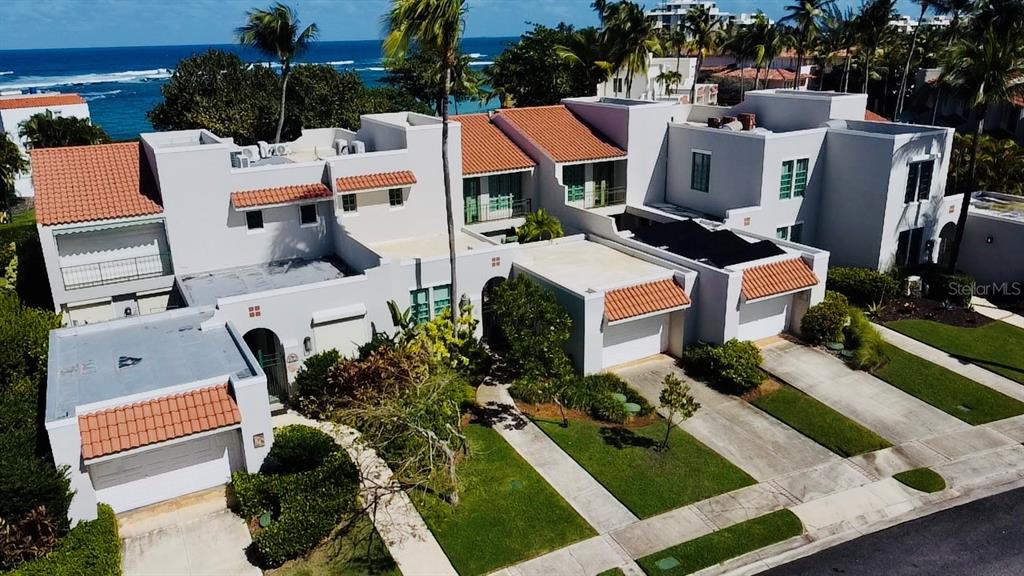 An aerial view of a multi-unit residential complex with white walls and terracotta roofs — Calle Arecife DORADO REEF UNIT P-65, DORADO, PR