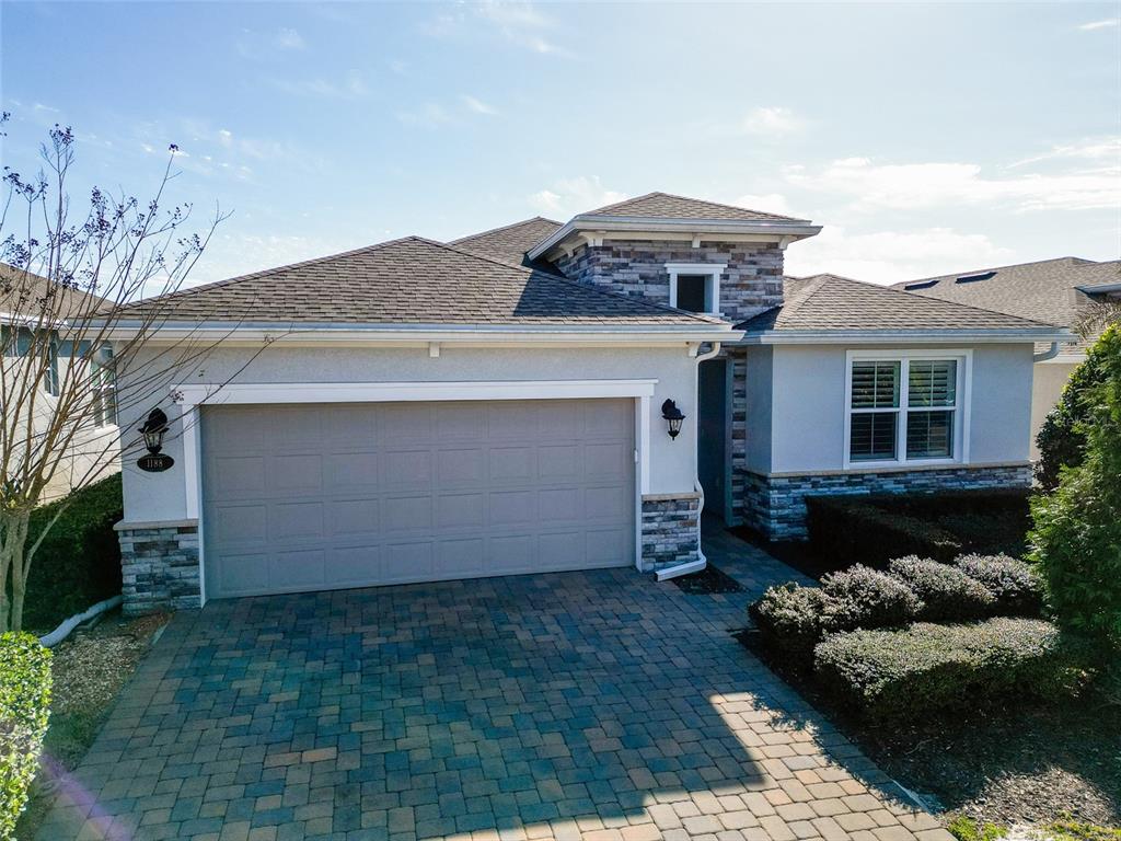 A single-story house with a stone-accented facade, a two-car garage, and a paved driveway — 1188 VICTORIA HILLS DRIVE N, DELAND, FL
