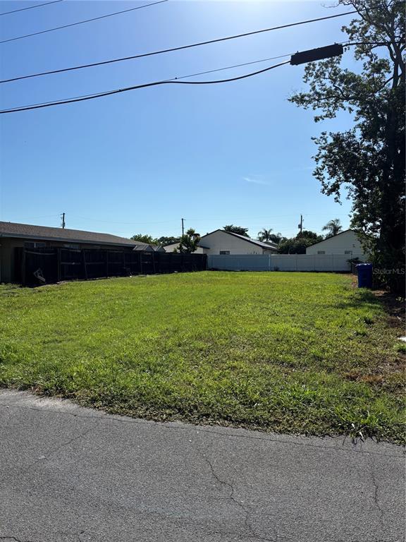 A digital rendering shows a two-story house with a garage and a list of specifications — 8021 N CLARK AVENUE, TAMPA, FL
