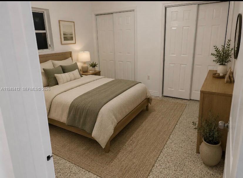 A bedroom features a bed with green bedding, a wooden dresser, and white closet doors — 626 NE 61st St # 5, Miami FL 33137, MIAMI, FL