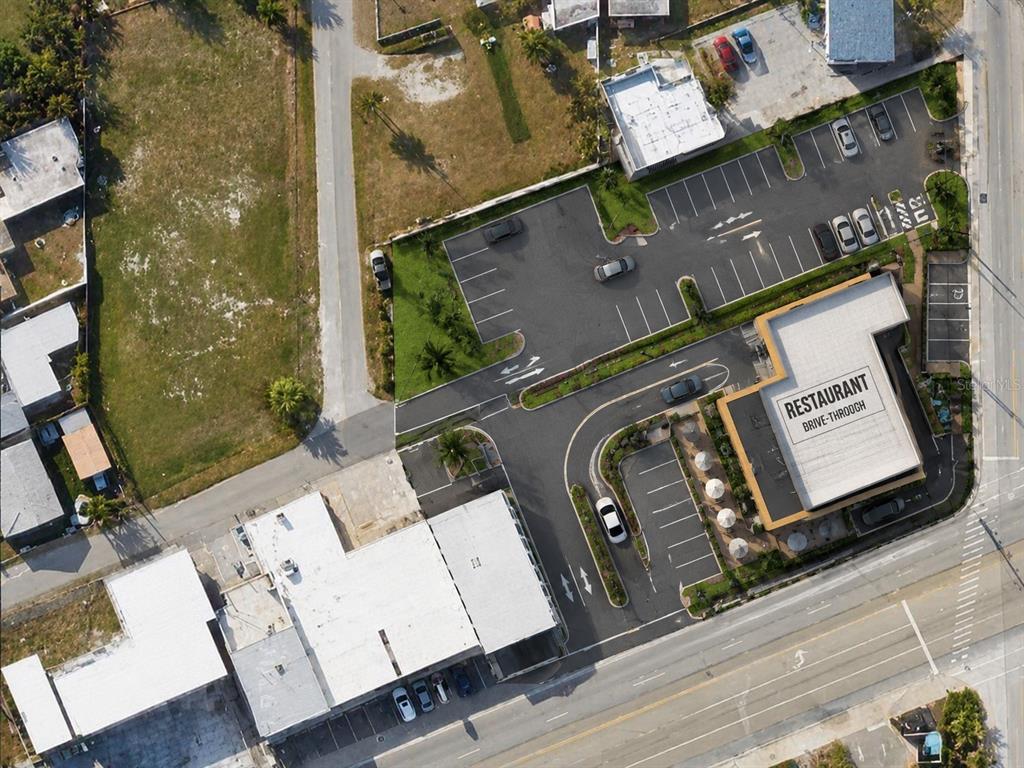 Aerial view of a commercial property featuring a restaurant with a drive-through and parking lot — 2006 S ATLANTIC AVENUE, DAYTONA BEACH, FL