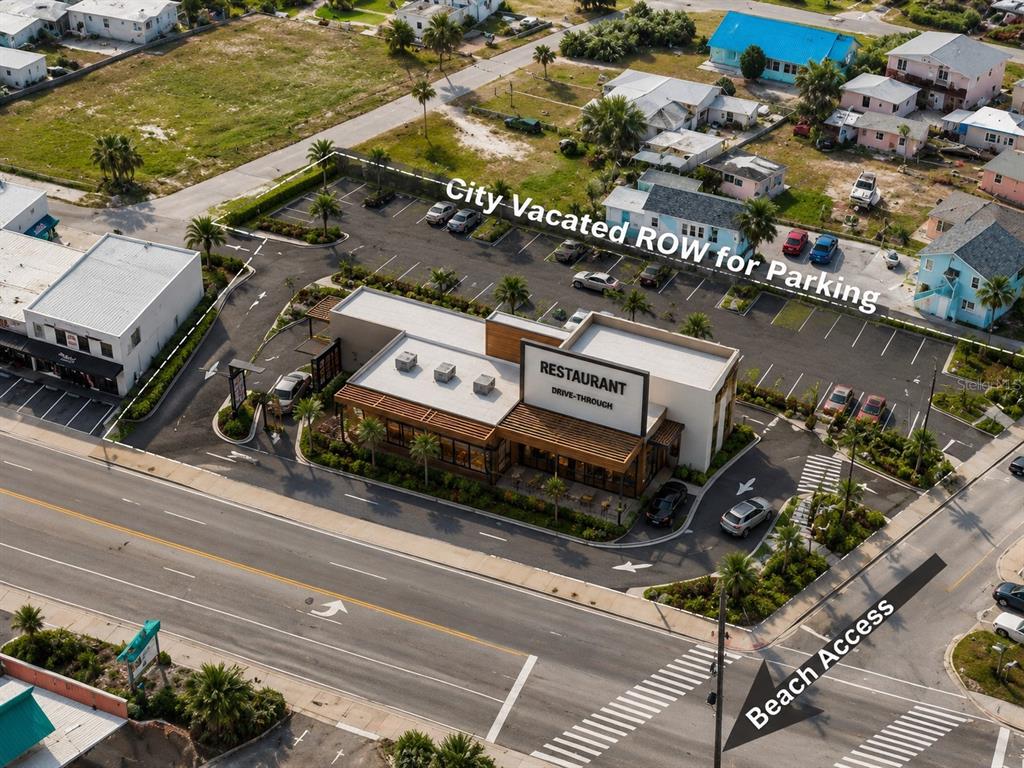 This aerial view shows a restaurant with a drive-thru, parking lot, and nearby beach access — 2006 S ATLANTIC AVENUE, DAYTONA BEACH, FL