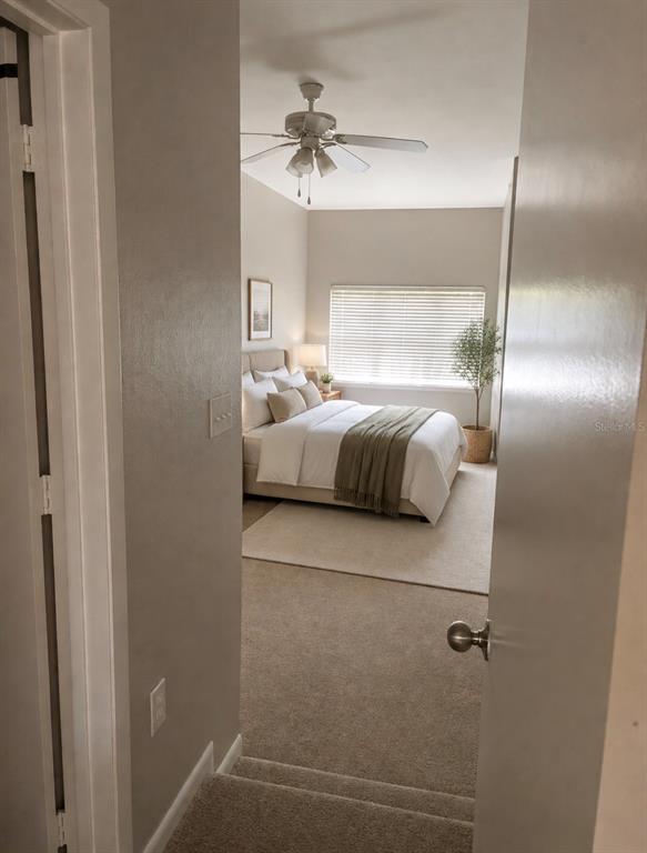 A view from a doorway looking down carpeted stairs into a furnished bedroom — 2411 W HORATIO STREET UNIT 538, TAMPA, FL