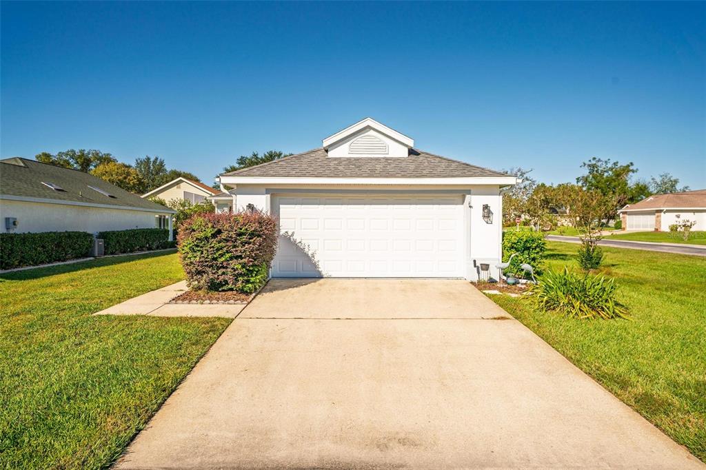 A single-story house with a white garage door and a concrete driveway — 2048 NW 50TH AVENUE, OCALA, FL