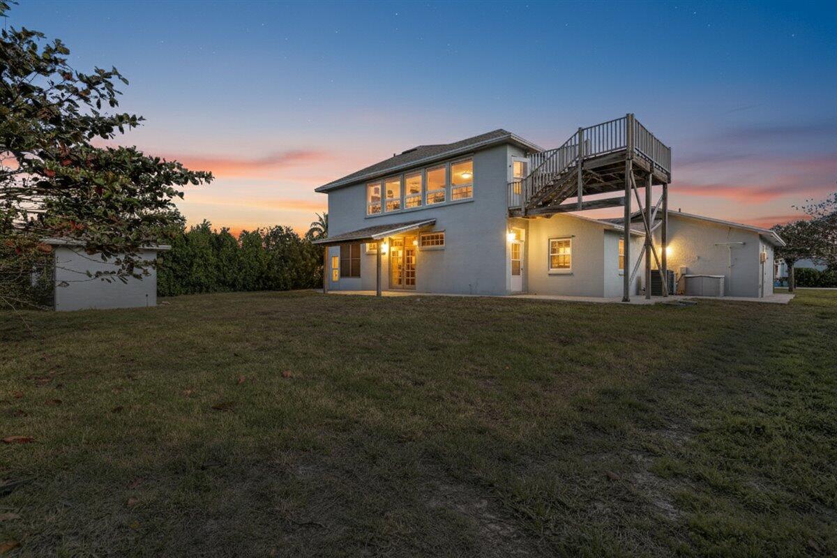 A two-story house with a large wooden exterior staircase leading to an upper deck — 2309 Atlantic Beach Boulevard, Fort Pierce FL 34949, FORT PIERCE, FL