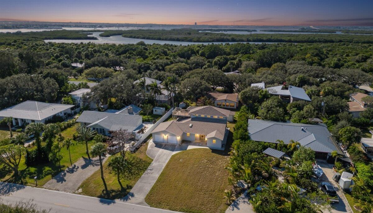 An aerial view of a suburban house with a large lawn and surrounding trees — 2309 Atlantic Beach Boulevard, Fort Pierce FL 34949, FORT PIERCE, FL
