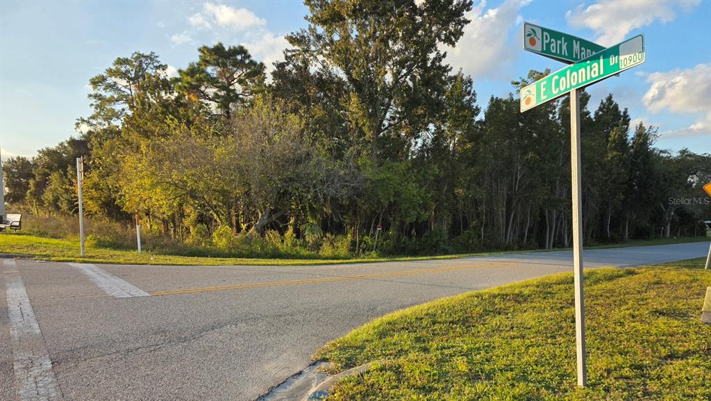 A street corner with a road sign showing Park Manor and E Colonial Drive — 10921 E COLONIAL DRIVE, ORLANDO, FL
