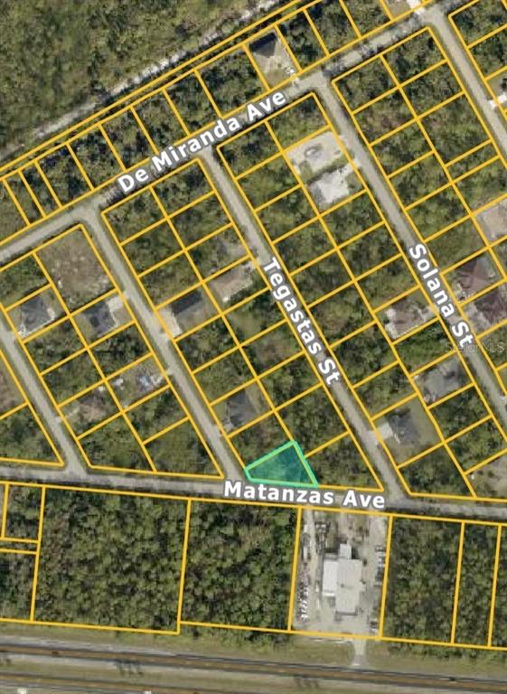 This is an aerial map showing a highlighted vacant lot at a street intersection — VESPUCIUS STREET, NORTH PORT, FL