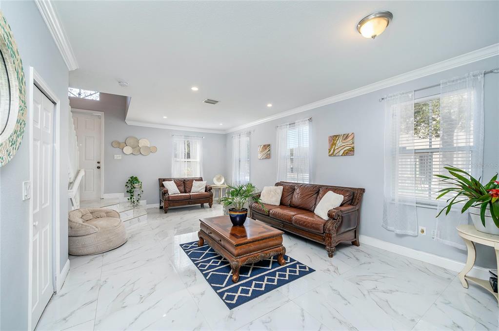 A living room features white marble floors, two brown leather sofas, and a coffee table — 13861 SW 273 TERRACE, HOMESTEAD, FL