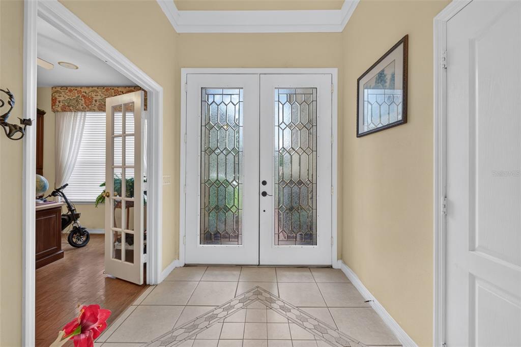 A tiled entryway features double glass-paneled doors and an adjacent room with French doors — 417 KEHOE BOULEVARD, ORLANDO, FL