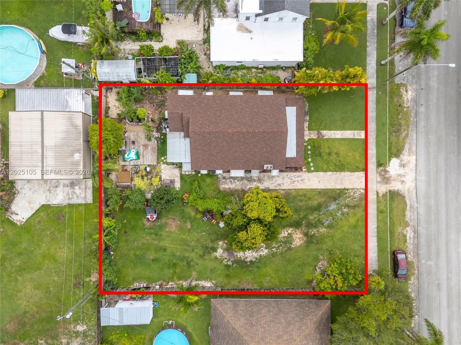 An aerial view shows a residential property with a house, yard, and driveway — 137 NW 20th St, Homestead FL 33030, HOMESTEAD, FL