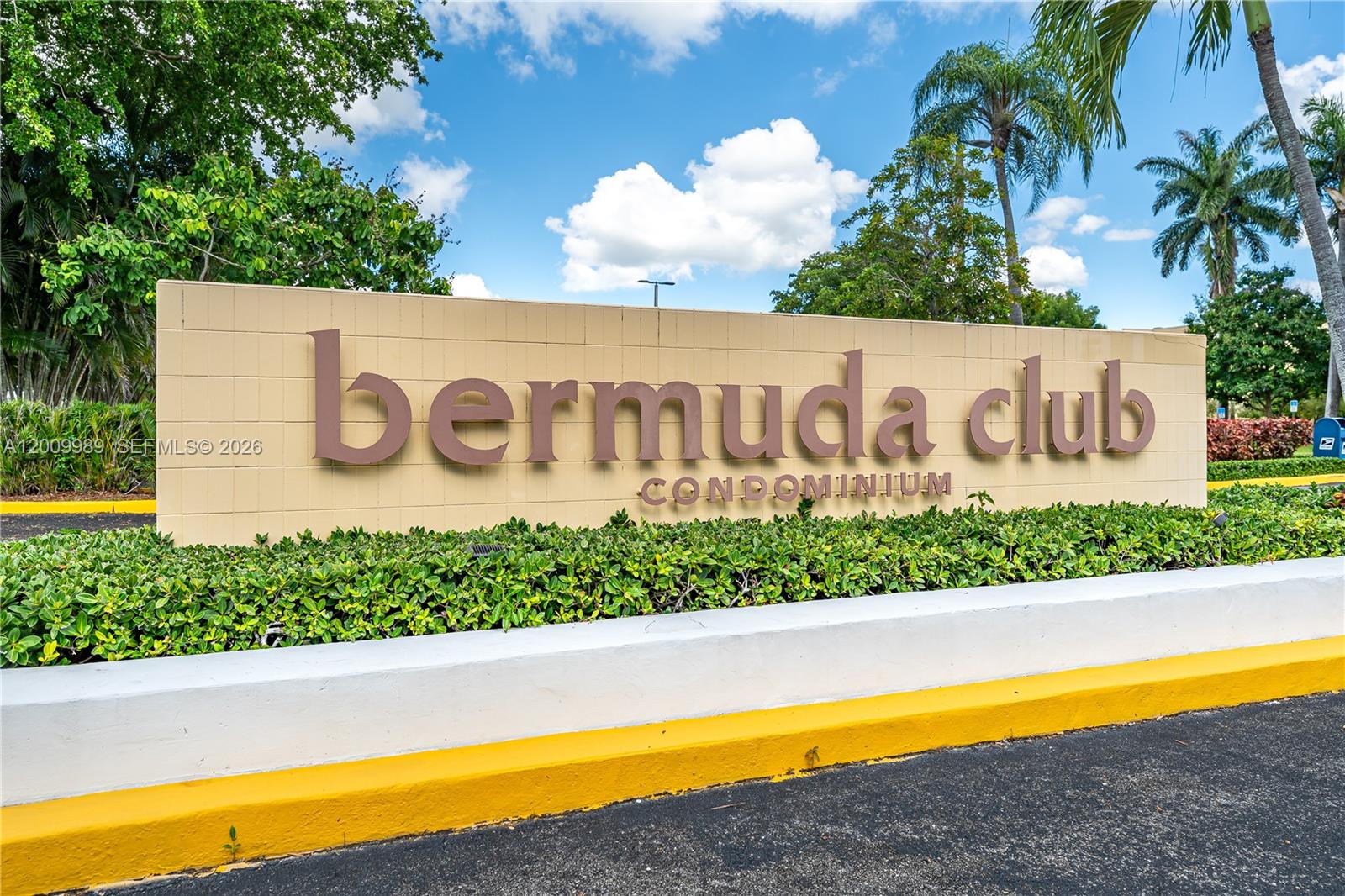 A tan wall sign with brown lettering reads Bermuda Club Condominium in a landscaped area — 5961 NW 61st Ave # 111, Tamarac FL 33319, TAMARAC, FL
