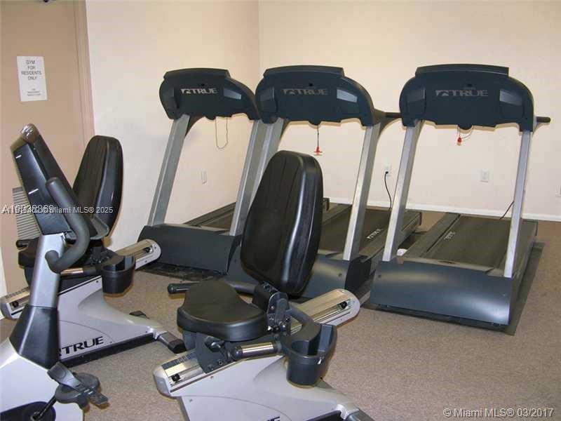 A small gym room contains three treadmills and two stationary recumbent bikes — 4174 Inverrary Dr # 1004, Lauderhill FL 33319, LAUDERHILL, FL