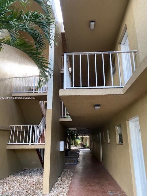 An exterior view of an apartment complex walkway with stairs and balconies — 4205 N University Dr # 208, Sunrise FL 33351, SUNRISE, FL