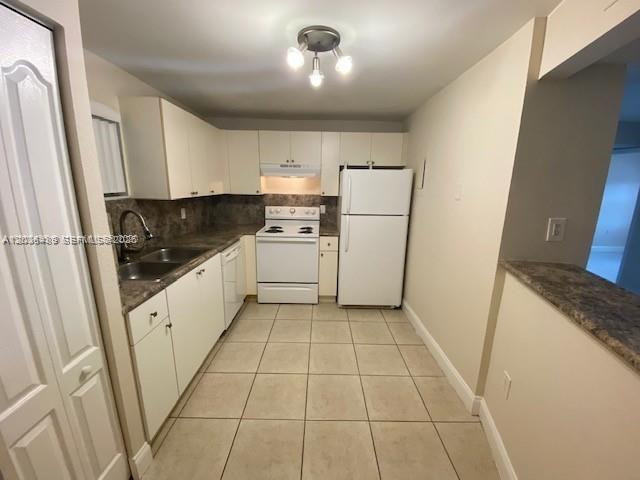 A kitchen with white cabinets, a white stove, a white refrigerator, and tiled flooring — 4205 N University Dr # 208, Sunrise FL 33351, SUNRISE, FL