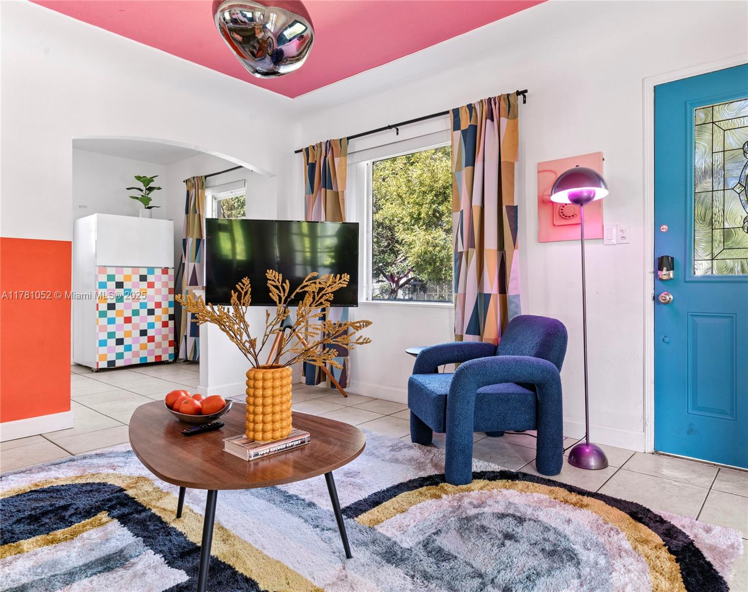 A living room features a pink ceiling, a blue door, and a colorful patterned rug — 260 NE 45th St, Miami FL 33137, MIAMI, FL