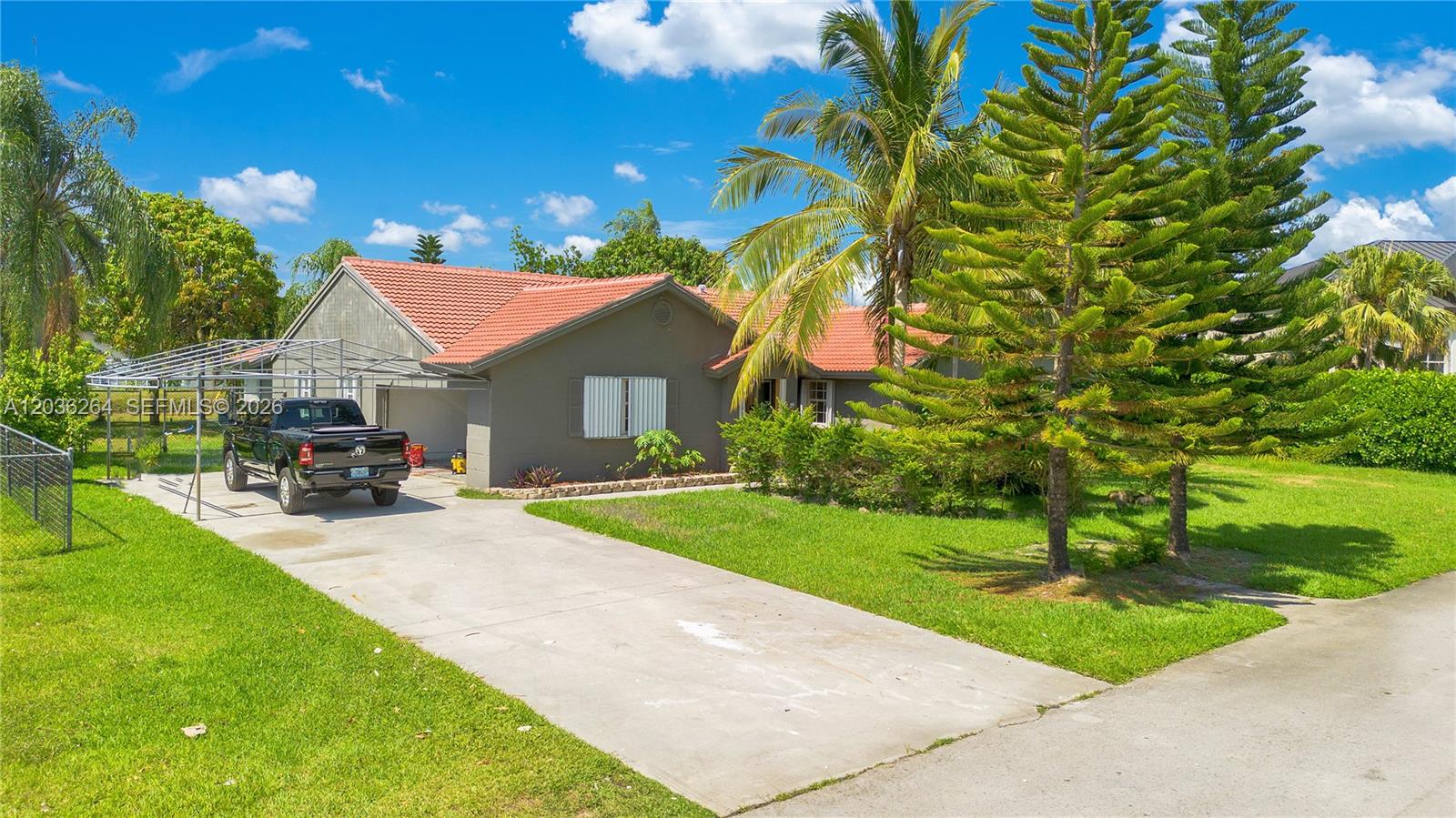 A single-story house with a red tile roof, a carport, and a concrete driveway — 15241 SW 150th St, Miami FL 33196, MIAMI, FL