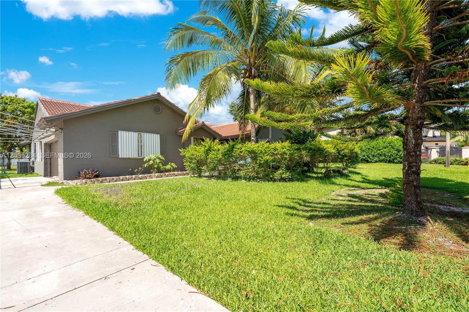A single-story house with a gray exterior, a tiled roof, and a large front lawn — 15241 SW 150th St, Miami FL 33196, MIAMI, FL