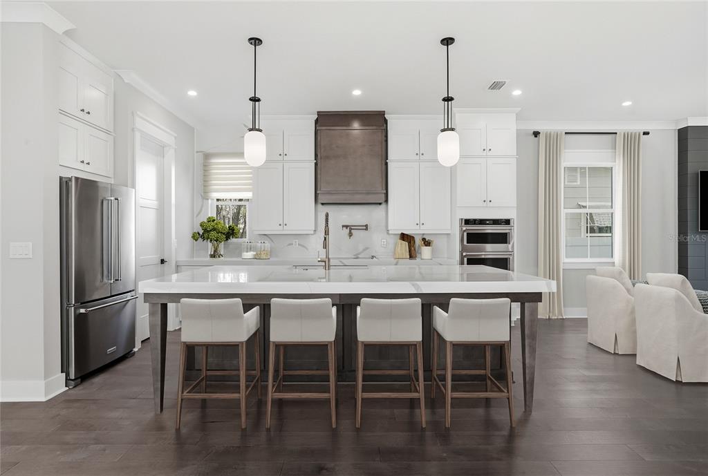 A living room features a black shiplap fireplace, light wood floors, and neutral furniture — 865 53RD AVENUE N, ST PETERSBURG, FL