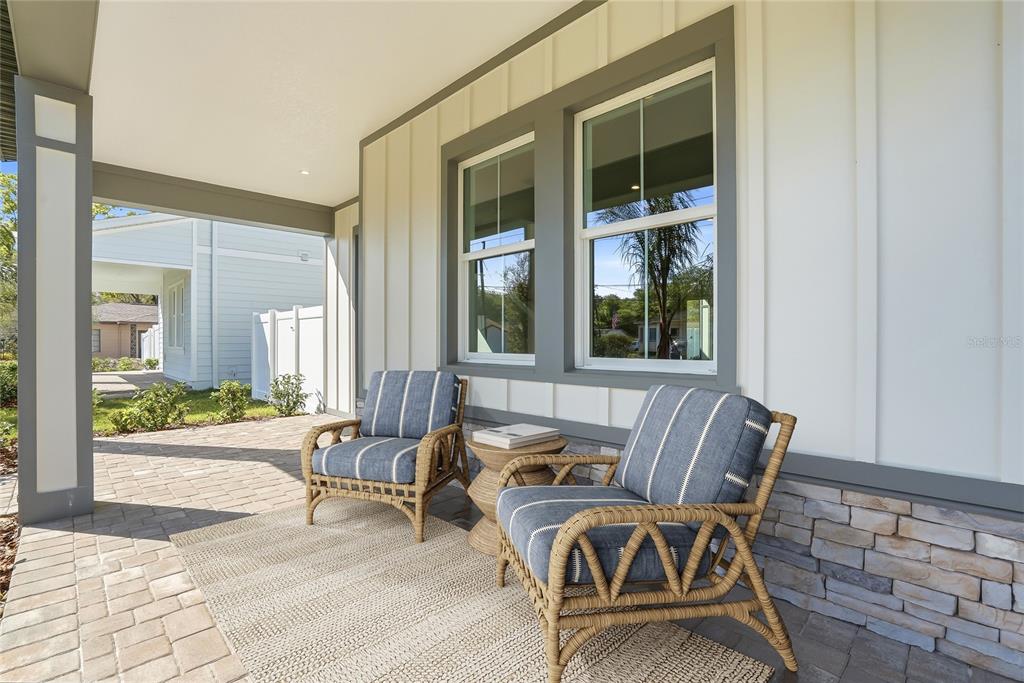 A living room features a black shiplap fireplace wall, light-colored furniture, and hardwood floors — 865 53RD AVENUE N, ST PETERSBURG, FL