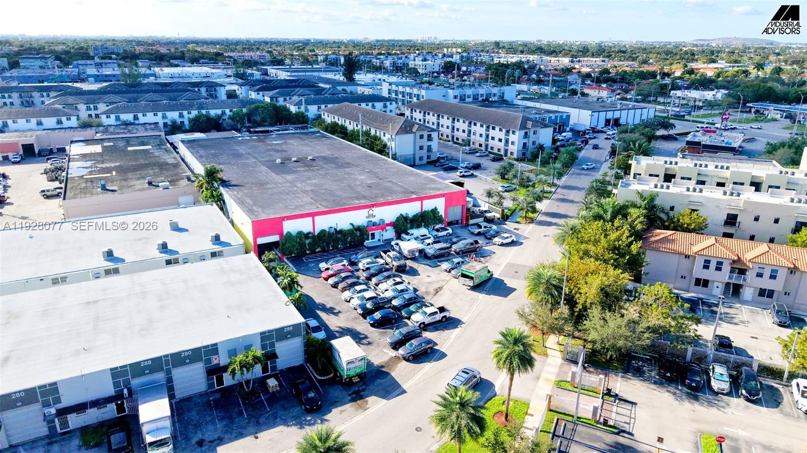 An aerial view shows a commercial warehouse building with a parking lot and surrounding properties — 290 W 78th Rd, Hialeah FL 33014, HIALEAH, FL