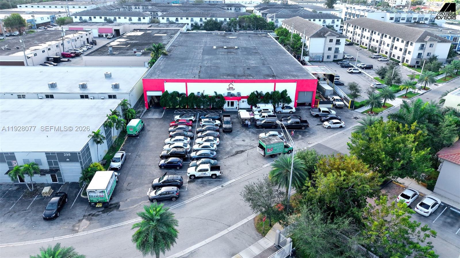 An aerial view shows a commercial building with a parking lot filled with various vehicles — 290 W 78th Rd, Hialeah FL 33014, HIALEAH, FL