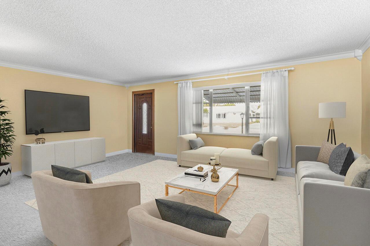This is a digitally staged living room with light yellow walls, carpeting, and a large window — 1802 SW 13th Avenue, Boynton Beach FL 33426, BOYNTON BEACH, FL