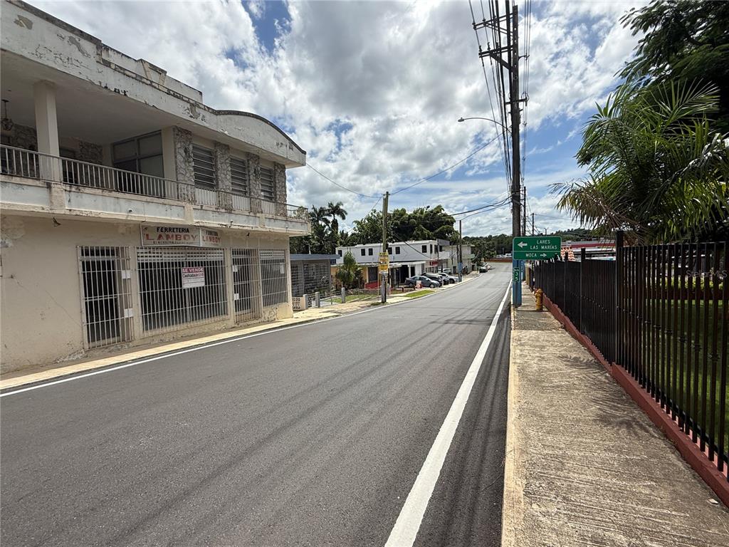 A two-story building with a hardware store on the ground floor sits beside a road — 12 HOSTOS CABRERA ST., SAN SEBASTIAN, PR