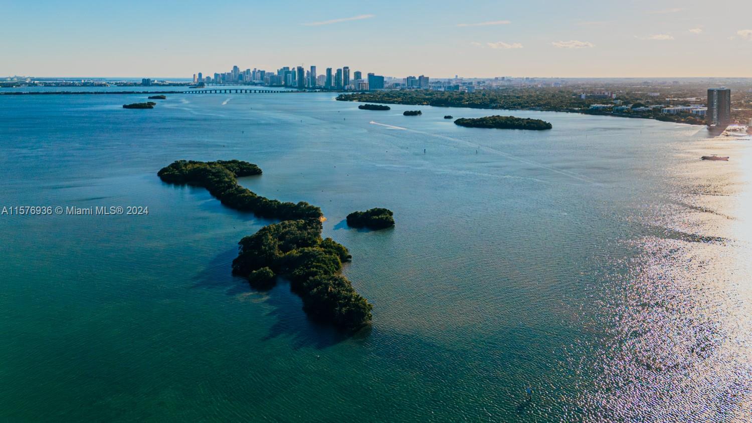 An aerial view shows mangrove islands in Biscayne Bay with the Miami skyline in the distance — 1 BIRD KEY, Miami FL 33138, MIAMI, FL