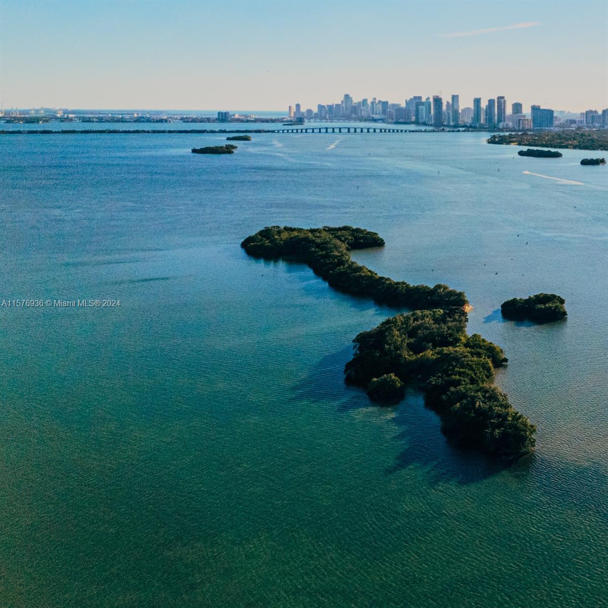 An aerial view shows mangrove islands in Biscayne Bay with the Miami skyline in the distance — 1 BIRD KEY, Miami FL 33138, MIAMI, FL