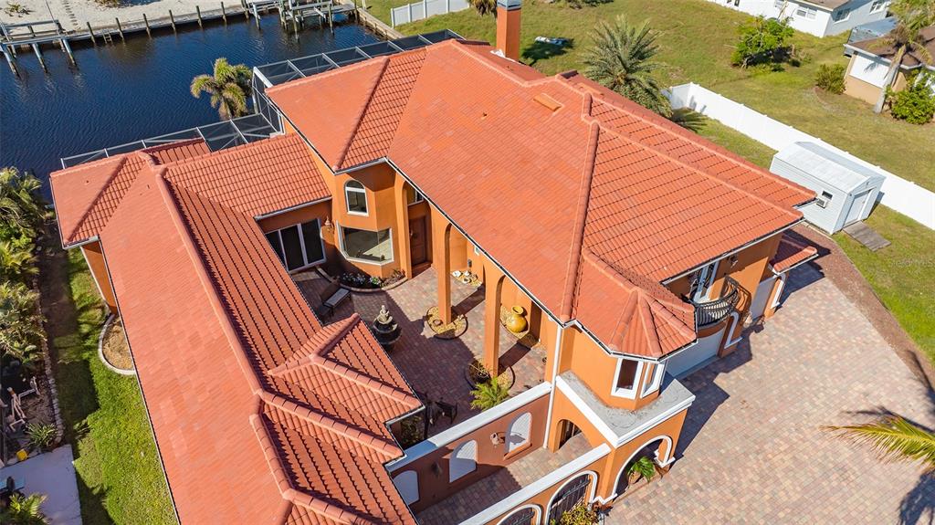 An aerial view of a two-story house with a terracotta tile roof and central courtyard — 108 ROSELLE COURT, PORT CHARLOTTE, FL