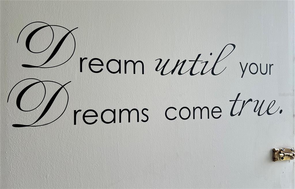 A wall decal with the text "Dream until your dreams come true" is applied to a wall — 935 S ATLANTIC AVENUE UNIT 303, DAYTONA BEACH, FL