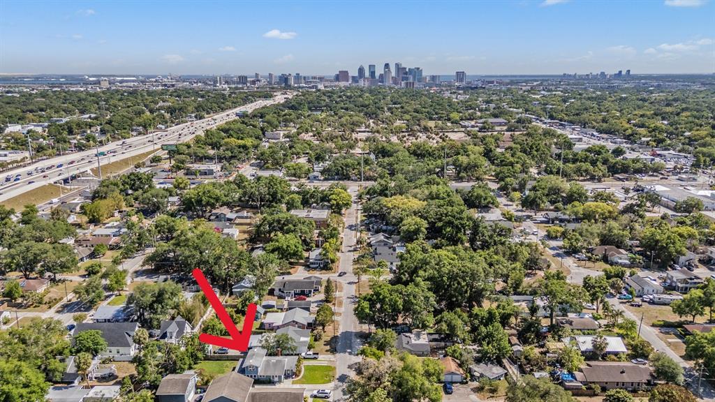 An aerial view shows a residential neighborhood with a red arrow pointing to a house — 4109 N SEMINOLE AVENUE, TAMPA, FL