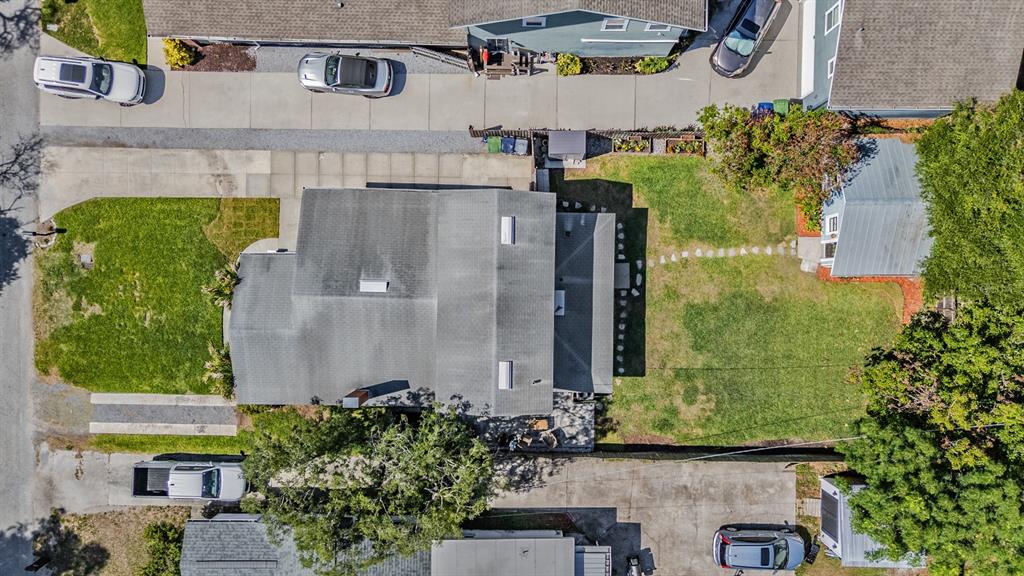 A sunlit street lined with mature trees draped in Spanish moss and residential houses — 4109 N SEMINOLE AVENUE, TAMPA, FL