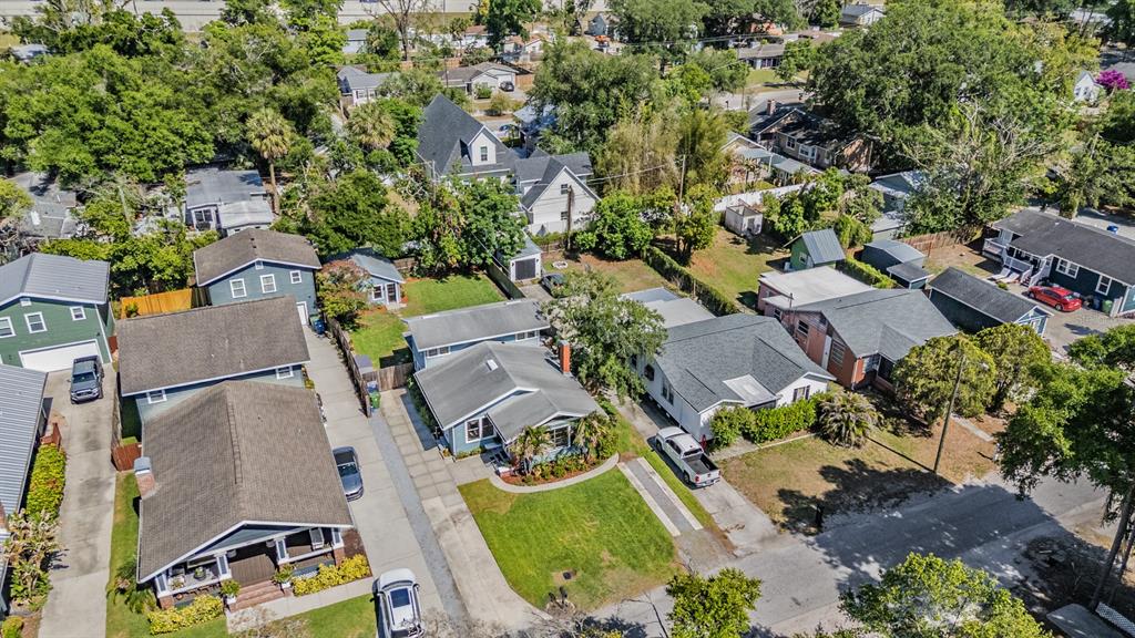 A light blue, two-story house with a brick chimney and a front lawn at dusk — 4109 N SEMINOLE AVENUE, TAMPA, FL