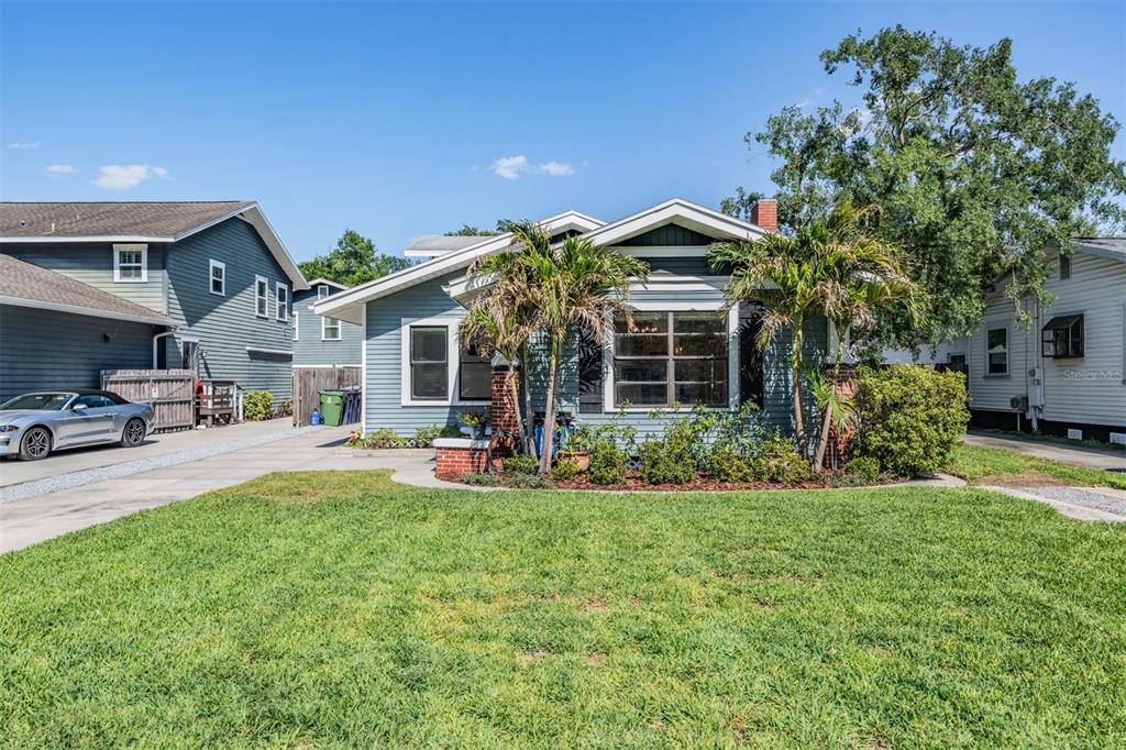An aerial view shows a residential house with a gray roof, driveway, and backyard — 4109 N SEMINOLE AVENUE, TAMPA, FL