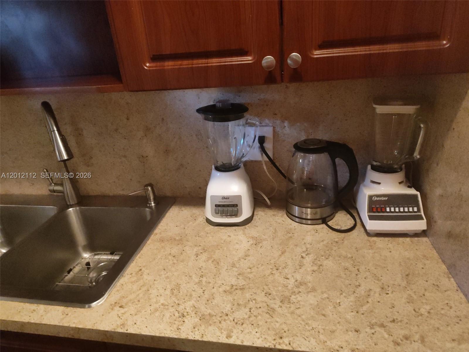 A kitchen counter features a stainless steel sink, two blenders, and an electric kettle — 625 SW 20th Ct # 8A, Delray Beach FL 33445, DELRAY BEACH, FL