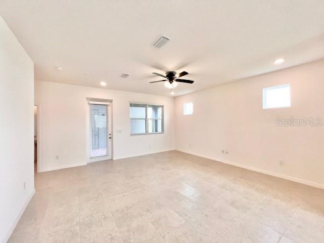 An empty room with light-colored tile flooring, a ceiling fan, and a glass door — 1638 ACCLAIM ROAD, APOPKA, FL